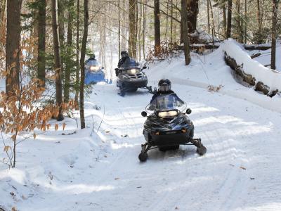 Snowmobiles Riding on Trail